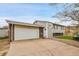 Charming multi-level home with an attached two-car garage, landscaped front yard with stone path at 228 Birch Ave, Castle Rock, CO 80104