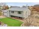 Two-story home with green lawn, gray siding, an attached two-car garage, and a lush side yard at 228 Birch Ave, Castle Rock, CO 80104
