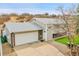 Charming home with a two-car garage, brick accents, green grass, and well-kept landscape at 228 Birch Ave, Castle Rock, CO 80104
