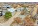View of home with large metal outbuilding and ample parking space in an arid, hillside setting at 228 Birch Ave, Castle Rock, CO 80104