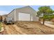 Large detached garage on a lot with a long driveway and some landscaping in the front at 228 Birch Ave, Castle Rock, CO 80104