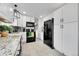 This kitchen features white cabinets, white countertops, and black appliances at 228 Birch Ave, Castle Rock, CO 80104