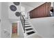 Bright staircase with black metal railings and white walls and floors that lead to another floor and a bedroom at 228 Birch Ave, Castle Rock, CO 80104
