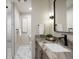 Modern bathroom featuring granite countertop vanity and walk-in shower with sleek fixtures at 23030 E Del Norte Cir, Aurora, CO 80016