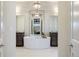 Spa-like bathroom featuring a soaking tub, dual vanities, and elegant lighting at 23030 E Del Norte Cir, Aurora, CO 80016