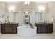 Luxurious bathroom with a freestanding tub, double vanities, and modern fixtures at 23030 E Del Norte Cir, Aurora, CO 80016