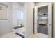 Elegant walk-in shower featuring sleek glass enclosure, built-in bench, and tiled walls at 23030 E Del Norte Cir, Aurora, CO 80016