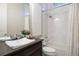 A sleek, modern bathroom with white tiled shower walls, modern fixtures, and a contemporary vessel sink at 23030 E Del Norte Cir, Aurora, CO 80016