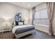 Cozy bedroom with plush bedding, decorative pillows, and soft natural light through the window at 23030 E Del Norte Cir, Aurora, CO 80016