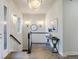 Bright hallway with hardwood floors, elegant lighting fixtures, and a decorative console table at 23030 E Del Norte Cir, Aurora, CO 80016