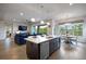 Bright open kitchen concept with an island and seating overlooking living and dining area at 23030 E Del Norte Cir, Aurora, CO 80016
