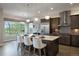 Bright, modern kitchen features a large island, stainless steel appliances, and ample cabinet space at 23030 E Del Norte Cir, Aurora, CO 80016