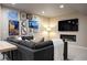 Cozy living room featuring large sectional sofa, gallery wall, and a modern fireplace at 23030 E Del Norte Cir, Aurora, CO 80016