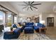Open-concept living room with plush blue sectional sofa and view into kitchen at 23030 E Del Norte Cir, Aurora, CO 80016