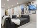 Spacious living area featuring a large sectional sofa with a curated gallery wall at 23030 E Del Norte Cir, Aurora, CO 80016