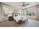Comfortable main bedroom featuring large windows, soft carpet, and a cozy sitting area at 23030 E Del Norte Cir, Aurora, CO 80016