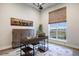 Bright office space featuring a stylish desk, cabinet, and large window with natural light at 23030 E Del Norte Cir, Aurora, CO 80016