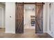 Inviting home office featuring rustic barn doors, desk, and stylish decor at 23030 E Del Norte Cir, Aurora, CO 80016