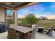 Outdoor patio featuring a dining table and chairs with views of a grassy backyard and neighborhood homes at 23030 E Del Norte Cir, Aurora, CO 80016