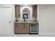 Basement wet bar features a modern color scheme, updated cabinetry, and a built-in wine cooler at 23030 E Del Norte Cir, Aurora, CO 80016
