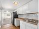 Efficient kitchen featuring ample counter space, white cabinetry, and a convenient double sink at 444 S Jersey St, Denver, CO 80224