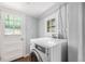 Functional laundry room with washer, bright natural light, and an easy access exterior door at 444 S Jersey St, Denver, CO 80224