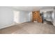 Spacious living area with new carpet, neutral paint, and easy access to kitchen and bedrooms at 444 S Jersey St, Denver, CO 80224