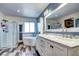 Bright bathroom featuring double sinks, walk-in shower, soaking tub, and modern fixtures at 1313 Iris Cir, Broomfield, CO 80020