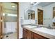 A well-lit bathroom featuring a double sink vanity, ample cabinet space, and walk-in bathtub at 1313 Iris Cir, Broomfield, CO 80020