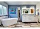Lovely bathroom featuring a soaking tub, double vanity, and a decorative turtle art piece at 1313 Iris Cir, Broomfield, CO 80020