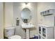 Cozy bathroom with pedestal sink, oval mirror, and clean, neutral decor at 1313 Iris Cir, Broomfield, CO 80020