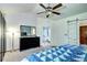 A view of a Primary bedroom with ensuite bath, with grey carpet and a decorative ceiling fan at 1313 Iris Cir, Broomfield, CO 80020