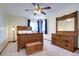 Bedroom with traditional wooden furniture, carpeted floor, and a decorative ceiling fan at 1313 Iris Cir, Broomfield, CO 80020