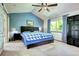 This bedroom features a blue accent wall, carpeted floor, and a decorative ceiling fan at 1313 Iris Cir, Broomfield, CO 80020
