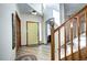Bright foyer with wood-look flooring, a yellow front door, and a staircase leading upstairs at 1313 Iris Cir, Broomfield, CO 80020