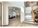 Spacious foyer with hardwood floors, staircase, and view into living room and dining area at 1313 Iris Cir, Broomfield, CO 80020