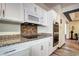 Modern kitchen with granite countertops, stainless steel appliances and tile backsplash at 1313 Iris Cir, Broomfield, CO 80020
