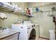 Efficient laundry room with ample storage space and modern washer and dryer units at 1313 Iris Cir, Broomfield, CO 80020