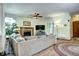 Cozy living room with brick fireplace and ceiling fan, perfect for relaxation at 1313 Iris Cir, Broomfield, CO 80020