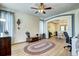 Cozy living room with hardwood floors, a ceiling fan, and an archway leading to the dining room at 1313 Iris Cir, Broomfield, CO 80020