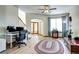 Open-concept living room with wood floors, large windows, and a view into the foyer and dining room at 1313 Iris Cir, Broomfield, CO 80020
