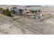Wide angle aerial view of a gray house, a green roofed barn, outbuildings, fenced areas, and surrounding acreage at 5910 Mccart Ranch Cir, Elizabeth, CO 80107