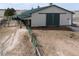 Exterior of a large barn with green roof and white siding and multiple horse runs at 5910 Mccart Ranch Cir, Elizabeth, CO 80107