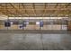 Indoor view of a horse barn with wooden stalls and individual access doors at 5910 Mccart Ranch Cir, Elizabeth, CO 80107