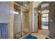 Updated bathroom with glass enclosed shower with tile and view of the bedroom through the arched doorway at 5910 Mccart Ranch Cir, Elizabeth, CO 80107