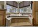 Large soaking tub with a marble surround, with large windows for natural light and scenic views at 5910 Mccart Ranch Cir, Elizabeth, CO 80107