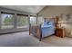 Spacious bedroom with large windows offering scenic views and natural light and a unique rustic bed frame at 5910 Mccart Ranch Cir, Elizabeth, CO 80107