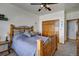 Comfortable bedroom with a ceiling fan, wood accents, and a walk-in closet at 5910 Mccart Ranch Cir, Elizabeth, CO 80107