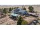 A gray two-story house with a spacious deck is complemented by a green roofed kennel and newly constructed wooden fence at 5910 Mccart Ranch Cir, Elizabeth, CO 80107