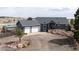 Stunning single-Gathering home boasts an attached three-car garage and well-maintained lawn at 5910 Mccart Ranch Cir, Elizabeth, CO 80107